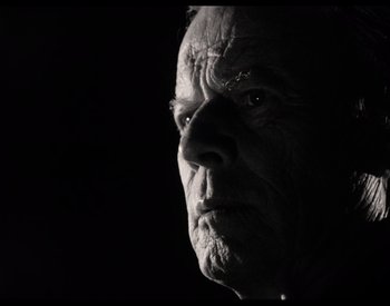 Movie still from “The Other Side of the Wind” (2018), directed by Orson Welles – An old man's face is shown in a black and white photo; Close Up shot, Low angle