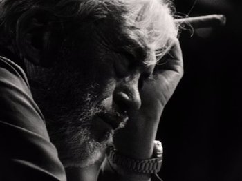 Movie still from “The Other Side of the Wind” (2018), directed by Orson Welles – An old man with a beard is looking down; Extreme Close Up shot, Low angle