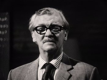 Movie still from “The Other Side of the Wind” (2018), directed by Orson Welles – An older man wearing a suit and tie; Close Up shot, Low angle