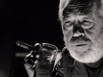Movie still from “The Other Side of the Wind” (2018), directed by Orson Welles – An older man holding a glass and a cigarette; Close Up shot, Low angle