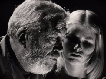 Movie still from “The Other Side of the Wind” (2018), directed by Orson Welles – An old man and a young girl looking into each others eyes; Close Up shot, Low angle