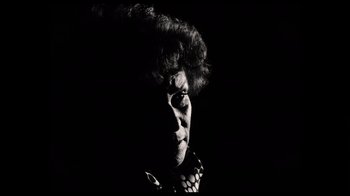 Movie still from “The Other Side of the Wind” (2018), directed by Orson Welles – An older woman is looking at the camera; Extreme Close Up shot, Low angle