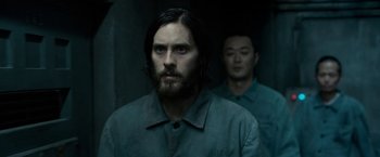Movie still from “The Outsider” (2018), directed by Martin Zandvliet – A man with long hair and a goatee standing next to another man with short hair; Close Up shot, Over the shoulder angle