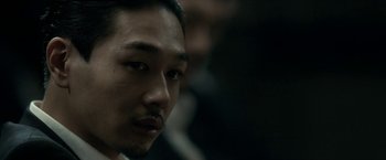 Movie still from “The Outsider” (2018), directed by Martin Zandvliet – A person with a mustache; Close Up shot, Over the shoulder angle
