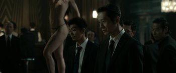 Movie still from “The Outsider” (2018), directed by Martin Zandvliet – A couple of men standing next to each other in a room; Medium shot, Over the shoulder angle