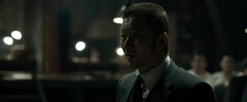 Movie still from “The Outsider” (2018), directed by Martin Zandvliet – A person wearing a suit and tie; Close Up shot, Over the shoulder angle