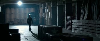 Movie still from “The Outsider” (2018), directed by Martin Zandvliet – A man in a suit walking through a warehouse; Wide shot, Low angle