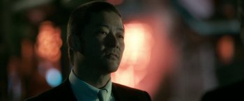 Movie still from “The Outsider” (2018), directed by Martin Zandvliet – A person wearing a suit and tie; Close Up shot, Low angle