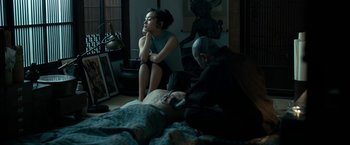 Movie still from “The Outsider” (2018), directed by Martin Zandvliet – A woman sitting on a bed next to a man; Medium shot, Over the shoulder angle