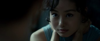 Movie still from “The Outsider” (2018), directed by Martin Zandvliet – A woman's face in a dark room; Close Up shot, Over the shoulder angle