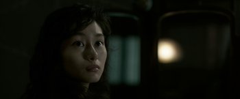 Movie still from “The Outsider” (2018), directed by Martin Zandvliet – A woman's face in the dark; Close Up shot, Over the shoulder angle