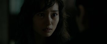 Movie still from “The Outsider” (2018), directed by Martin Zandvliet – A woman's face in the dark; Close Up shot, Over the shoulder angle