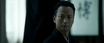 Movie still from “The Outsider” (2018), directed by Martin Zandvliet – A person wearing a black shirt; Close Up shot, Low angle