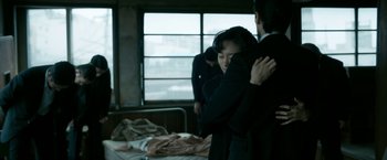 Movie still from “The Outsider” (2018), directed by Martin Zandvliet – A man and a woman hugging in a room; Medium shot, Over the shoulder angle
