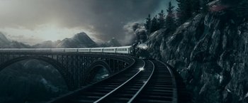 Movie still from “The Pale Blue Eye” (2022), directed by Scott Cooper – A train traveling over a bridge next to a forest; Extreme Wide shot, High angle