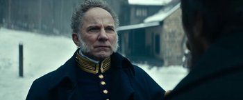 Movie still from “The Pale Blue Eye” (2022), directed by Scott Cooper – An older man in a military uniform looking at the camera; Close Up shot, Low angle