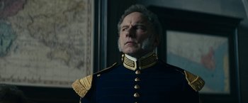 Movie still from “The Pale Blue Eye” (2022), directed by Scott Cooper – An older man in a military uniform looking at the camera; Close Up shot, Low angle