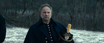 Movie still from “The Pale Blue Eye” (2022), directed by Scott Cooper – A man in a military uniform holding a hat; Close Up shot, Low angle