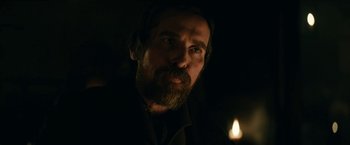 Movie still from “The Pale Blue Eye” (2022), directed by Scott Cooper – A man with a beard is looking at the camera; Close Up shot, Over the shoulder angle