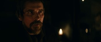 Movie still from “The Pale Blue Eye” (2022), directed by Scott Cooper – A man with a goatee and a beard stares at the camera; Close Up shot, Over the shoulder angle