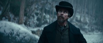 Movie still from “The Pale Blue Eye” (2022), directed by Scott Cooper – A man with a long beard wearing a black hat; Close Up shot, Low angle