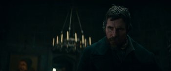 Movie still from “The Pale Blue Eye” (2022), directed by Scott Cooper – A person wearing a coat; Medium shot, Low angle