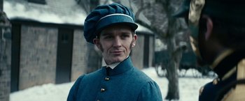 Movie still from “The Pale Blue Eye” (2022), directed by Scott Cooper – A man wearing a blue uniform and a blue hat; Close Up shot, Low angle