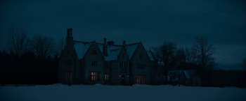 Movie still from “The Pale Blue Eye” (2022), directed by Scott Cooper – A large building with a lot of windows in the dark; Extreme Wide shot, Low angle