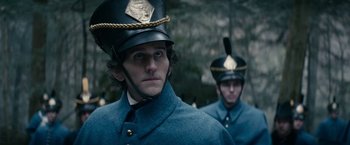 Movie still from “The Pale Blue Eye” (2022), directed by Scott Cooper – Two men in uniforms and hats are standing together; Close Up shot, Over the shoulder angle