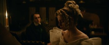 Movie still from “The Pale Blue Eye” (2022), directed by Scott Cooper – A man and a woman dressed up in period clothing; Close Up shot, Over the shoulder angle