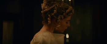 Movie still from “The Pale Blue Eye” (2022), directed by Scott Cooper – A person wearing a dress; Close Up shot, Over the shoulder angle