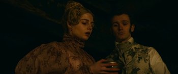 Movie still from “The Pale Blue Eye” (2022), directed by Scott Cooper – A man and a woman are holding a drink; Close Up shot, Low angle