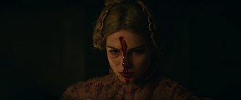 Movie still from “The Pale Blue Eye” (2022), directed by Scott Cooper – A young woman with a bloody nose and head wound; Close Up shot, Over the shoulder angle
