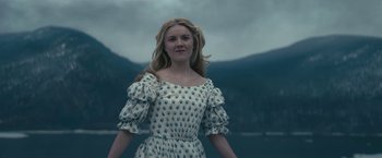 Movie still from “The Pale Blue Eye” (2022), directed by Scott Cooper – A woman standing in front of a body of water; Medium shot, Low angle