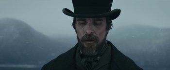 Movie still from “The Pale Blue Eye” (2022), directed by Scott Cooper – A person wearing a top hat; Close Up shot, Low angle
