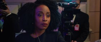 Movie still from “The Prom” (2020), directed by Ryan Murphy – A black woman with afro hair sitting in front of a video camera; Close Up shot, Over the shoulder angle