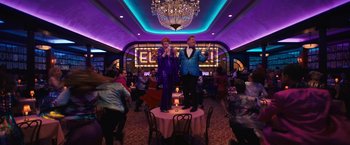 Movie still from “The Prom” (2020), directed by Ryan Murphy – A couple of people that are standing up on a table; Wide shot, Low angle