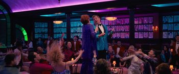 Movie still from “The Prom” (2020), directed by Ryan Murphy – A man and a woman singing in front of an audience; Wide shot, Over the shoulder angle