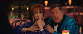 Movie still from “The Prom” (2020), directed by Ryan Murphy – A woman in a blue dress and a man in a black suit; Medium shot, Over the shoulder angle