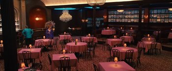 Movie still from “The Prom” (2020), directed by Ryan Murphy – A room filled with tables and chairs covered in pink linens; Extreme Wide shot, High angle