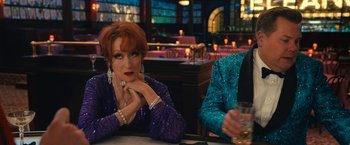 Movie still from “The Prom” (2020), directed by Ryan Murphy – Two women sitting at a table in front of a glass of wine; Medium shot, Over the shoulder angle