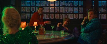 Movie still from “The Prom” (2020), directed by Ryan Murphy – A man and a woman sitting at a table with a martini glass; Wide shot, Over the shoulder angle