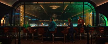 Movie still from “The Prom” (2020), directed by Ryan Murphy – A man and a woman sitting at a bar in front of a large window; Wide shot, High angle