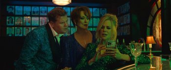 Movie still from “The Prom” (2020), directed by Ryan Murphy – A group of people standing next to each other in a room; Medium shot, Over the shoulder angle