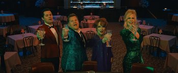 Movie still from “The Prom” (2020), directed by Ryan Murphy – A couple of people that are holding wine glasses; Medium shot, High angle