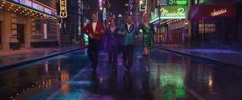 Movie still from “The Prom” (2020), directed by Ryan Murphy – A group of people walking down a street at night; Wide shot, High angle