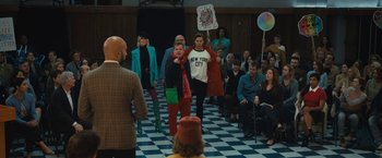 Movie still from “The Prom” (2020), directed by Ryan Murphy – A group of people standing in front of a group of people; Wide shot, Over the shoulder angle