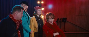 Movie still from “The Prom” (2020), directed by Ryan Murphy – A group of women standing next to each other; Medium shot, Over the shoulder angle