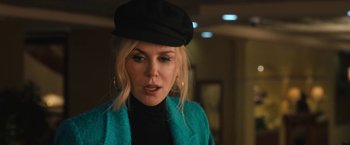 Movie still from “The Prom” (2020), directed by Ryan Murphy – A woman wearing a black hat and a blue jacket; Close Up shot, Over the shoulder angle