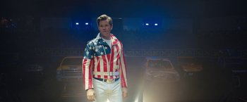 Movie still from “The Prom” (2020), directed by Ryan Murphy – A man wearing a jacket with the american flag on it; Medium shot, Over the shoulder angle